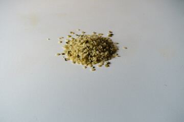 Handful of greenish yellow shelled hemp seeds
