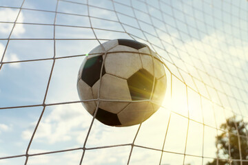 soccer field with a ball in goal against cloudy sky and the bright sun. the concept of success and victory. Summer game of European football © diy13