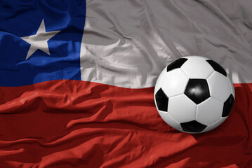 Naklejka premium vintage football ball on the waveing national flag of chile background. 3D illustration