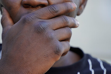unrecognizable portrait of quiet black person. victim of racism