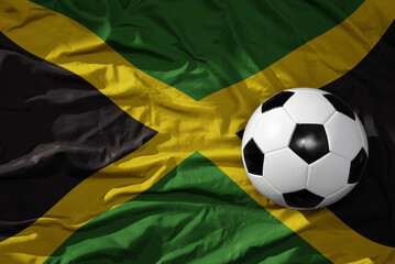 vintage football ball on the waveing national flag of jamaica background. 3D illustration - obrazy, fototapety, plakaty