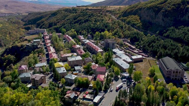 Aerial view Jermuk city in Armenia, Caucasian region. Jermuk mineral water resort town in Armenia, western Asia. Armenian mountain city Jermuk. Small resort town in autumn mountains.