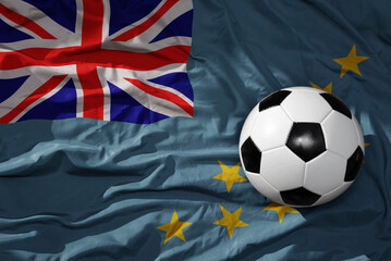 vintage football ball on the waveing national flag of Tuvalu background. 3D illustration