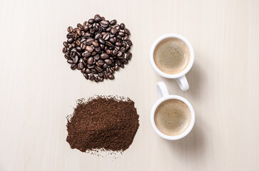 Two coffee cups or mugs with beans and ground coffee on wooden desk or table, I like, love coffee, close-up, coffee making concept