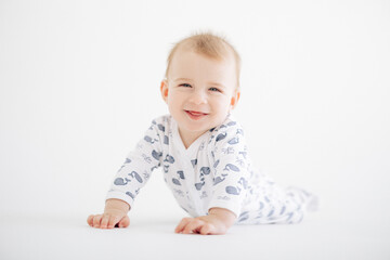Portrait of cute smiling and lying baby boy in romper.