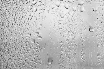 Glass in raindrops. Wet surface. Misted glass. Condensation on the window. Raindrops.