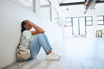 Sad, depression and anxiety student woman on floor in university campus classroom with stress for education scholarship. Depressed, burnout and tired college girl crying for fail, mistake or debt