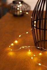 glowing yellow light bulbs garlands on a wooden table. Background and backdrop