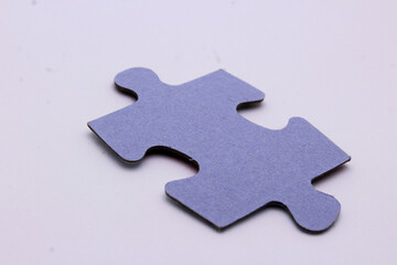 a piece of a puzzle on a white puzzle background