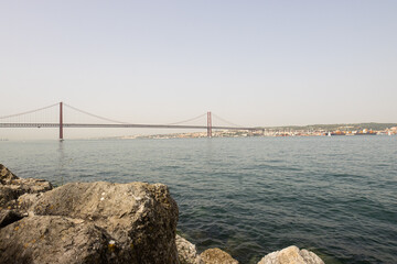 Bridge of 25 april - view of Lisboa Harbor with vessels and boats