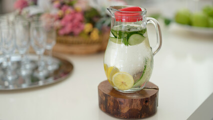 Fototapeta na wymiar Fruit water with lemon lime cucumber and mint in glass jug