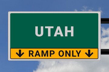 Utah logo.  Utah lettering on a road sign. Signpost at entrance to  Utah, USA. Green pointer in American style. Road sign in the United States of America. Sky in background