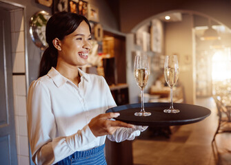 Waitress, wine glass tray and hospitality service in restaurant, cafe and fine dining winery. Happy...