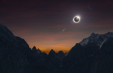 Total solar eclipse over high mountains, amazing dark mysterious scientific image