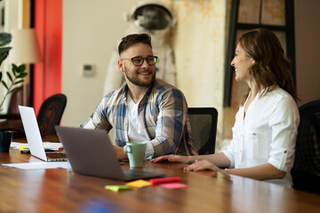 Colleagues in office. Businesswoman and businessman discussing work in office..