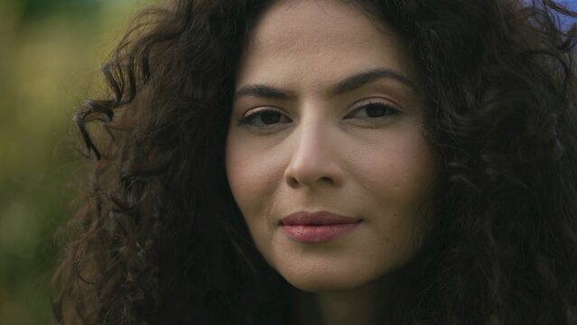 One hispanic latina woman closeup face looking at camera. South American famel person with serious expression