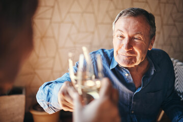 Toast, glass and couple with a senior man and woman doing a cheers in celebration of their anniversary while on a date. Dating, love and retirement with an elderly pensioner drinking champagne