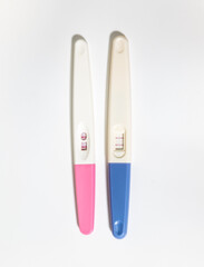 two positive pregnancy tests on a white background