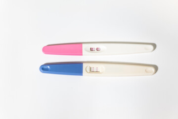 two positive pregnancy tests on a white background