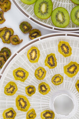 close-up, on round grills, cut fresh and dried kiwi fruit, top view