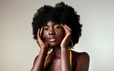 Black woman, fashion and face beauty in makeup against a mockup studio background. Portrait of an isolated beautiful African American model with stylish cosmetic art and afro hair style on copy space