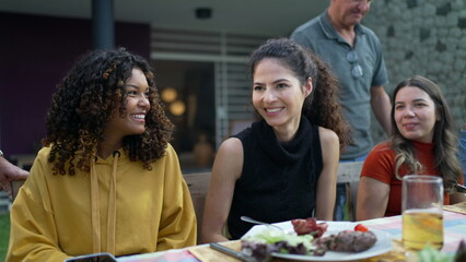 Friends conversing outdoors in home backyard barbecue. Diverse group of people talking at party 2