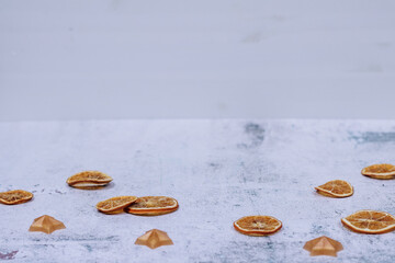 Winter white Christmas background or backdrop with dried orange slices and stars
