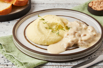 Creamy chicken pieces with mashed potatoes, closeup