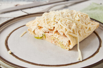 Crepes stuffed with Caesar salad, chicken, tomatoes, cheese and lettuce, closeup