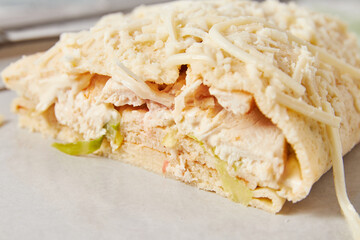 Crepes stuffed with Caesar salad, chicken, tomatoes, cheese and lettuce, closeup, similar