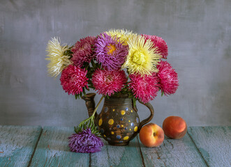 still life with a bouquet of asters and a ripe peach