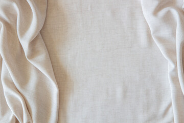 White crumpled linen fabric texture background. Natural off white wavy linen organic eco textiles...