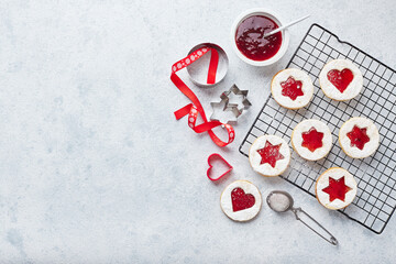 Classic Linzer Christmas Cookies with raspberry or strawberry jam on light background.