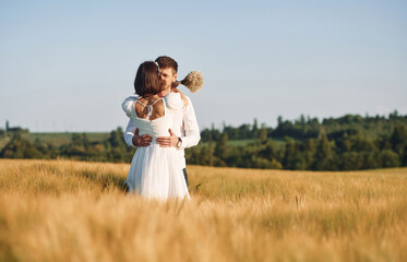 Couple just married. Together on the majestic agricultural field at sunny day