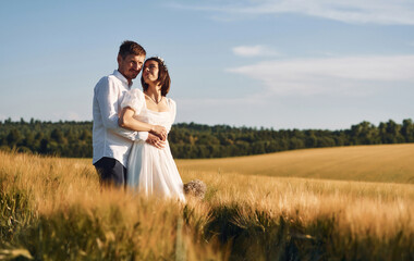 Couple just married. Together on the majestic agricultural field at sunny day