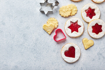 Classic Linzer Christmas Cookies with raspberry or strawberry jam on light background.