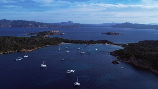 Aerial View Of Boats Moored Off Isola Di Caprera In The Tyrrhenian Sea. Dolly Back