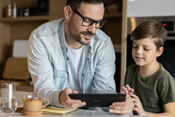 Father and son playing in kitchen, having a great family time!
