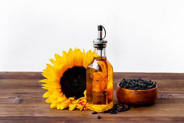 Yellow sunflowers with cooking oil and black seeds. Food background