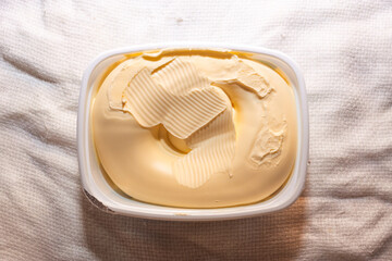Yellow margarine pot. Ingredient for recipes and food accompaniment - obrazy, fototapety, plakaty
