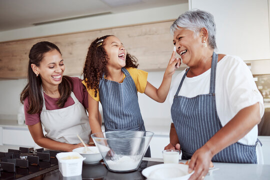 Women, happy family and bake food in kitchen smile together love cooking dessert and bonding at family home. Excited, happiness and smiling elderly grandmother, mom and girl kid baking fun at house