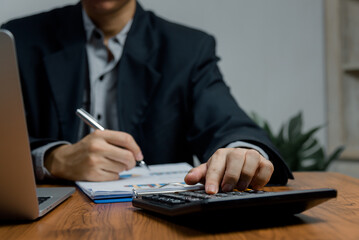 Business man investment finance calculating graph documents and report analysis economy accounting On the desk in office.