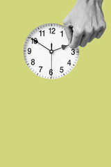 man resets a clock backward or forward