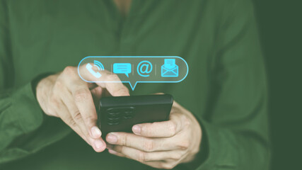 Customer support hotline Contact concept Customer service representative's hands are filling out information from mobile phone to computer. and notify the contact address to the service use