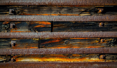 Old worn wooden background with rusty steel plates.