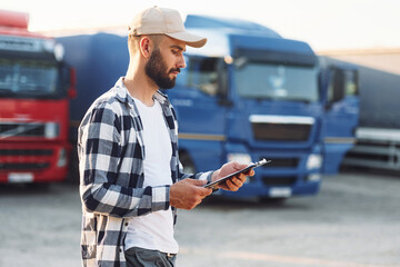 Young truck driver is with his vehicle at daytime