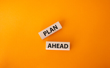 Plan ahead symbol. Wooden blocks with words Plan ahead. Beautiful orange background. Business and Plan ahead concept. Copy space.