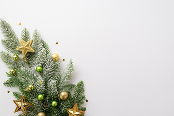 New Year concept. Top view photo of pine branch with gold and green baubles gold star ornaments and...
