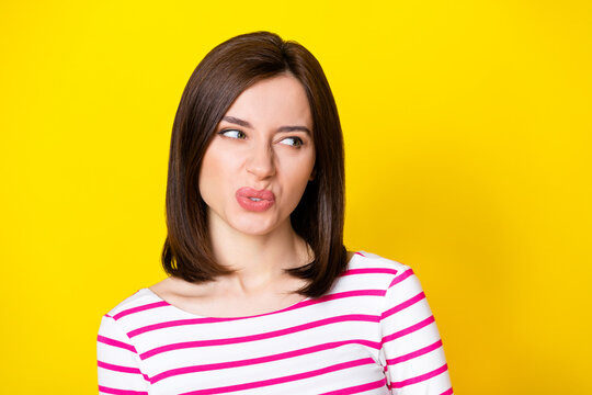 Closeup photo of young attractive nice woman looking empty space suspicious isolated on yellow color background