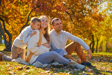 Fototapeta premium Young family, parents with their son are resting